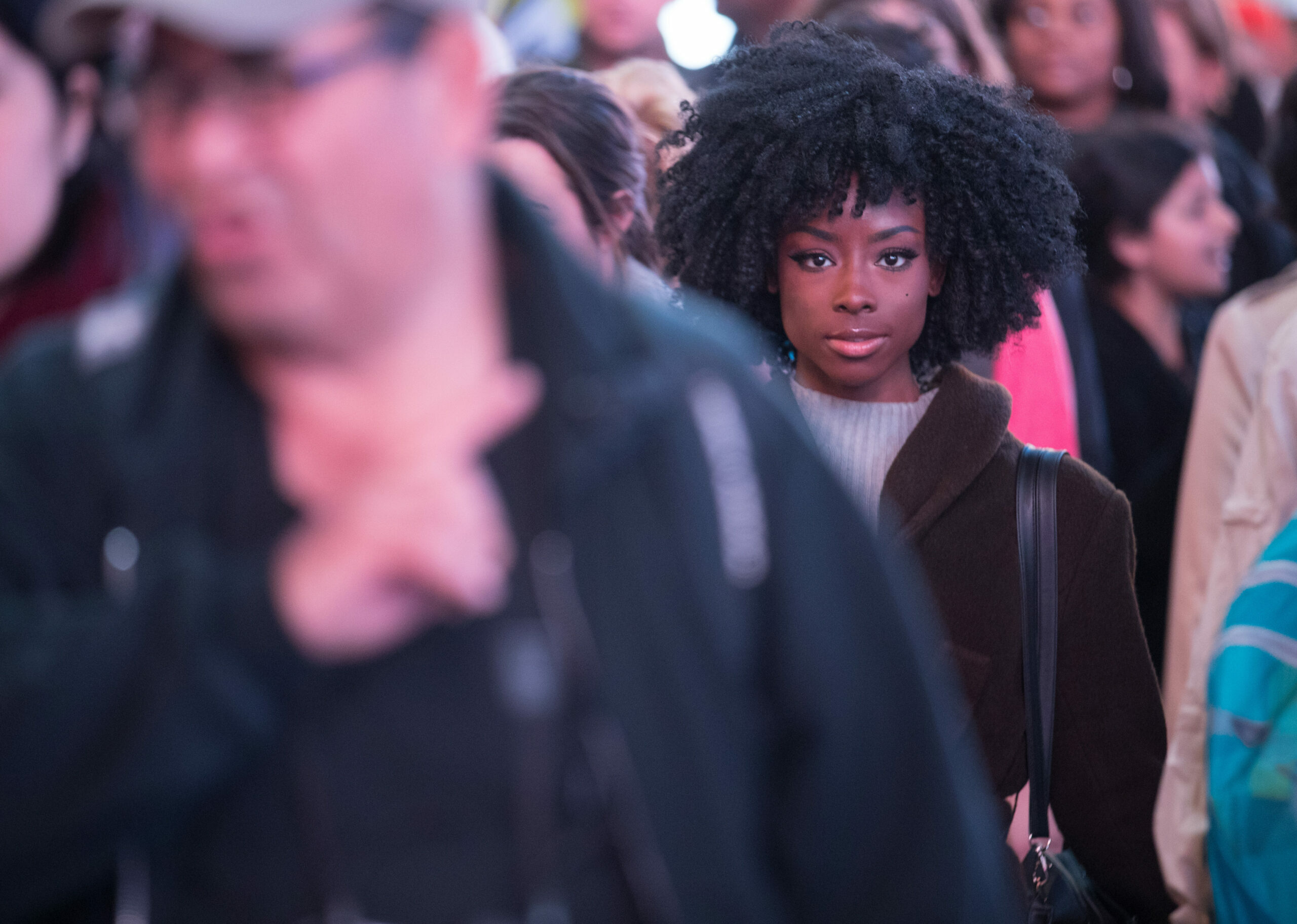 African American woman on a crowded city sidewalk living out her faith.