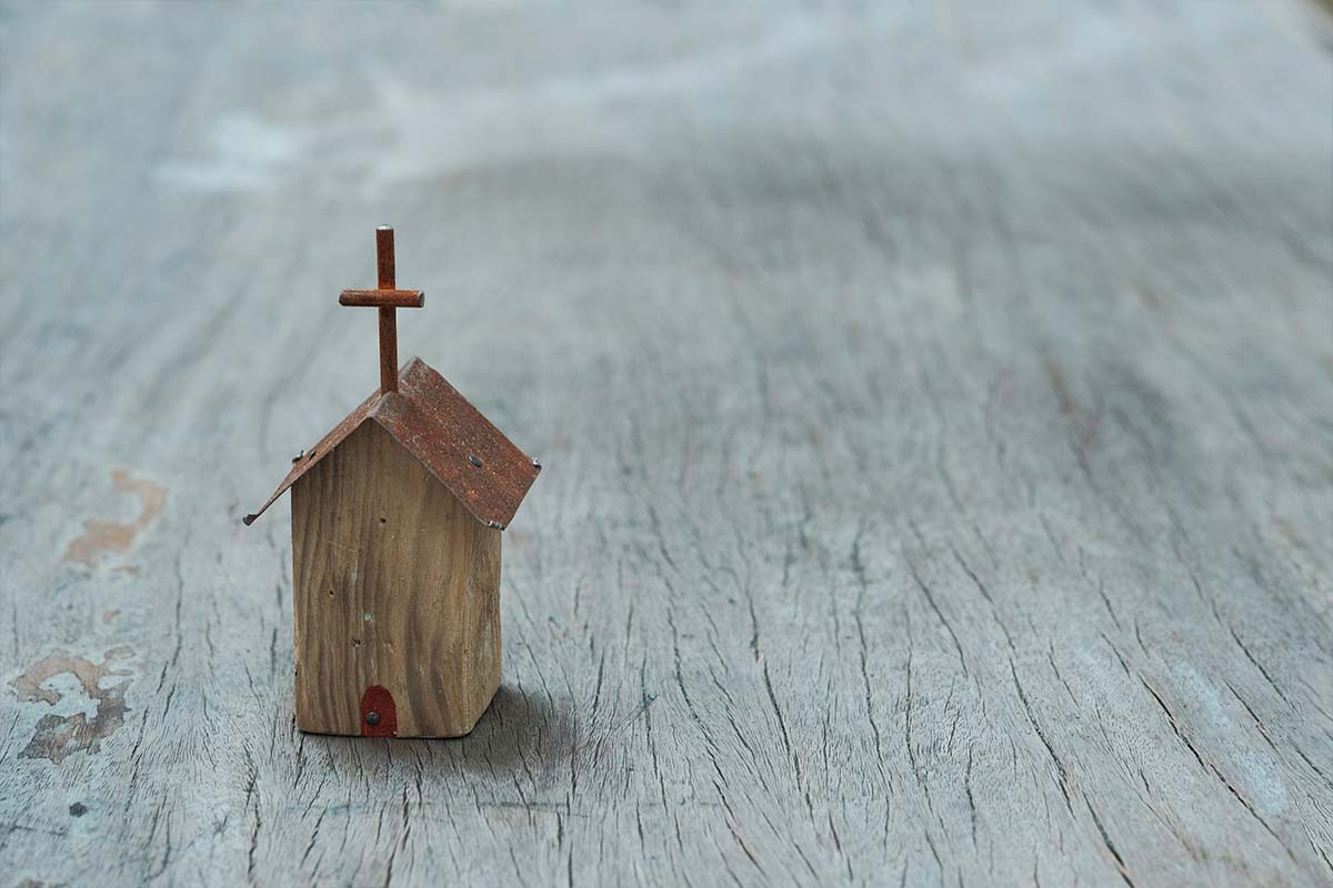 a small church sitting on a wood table