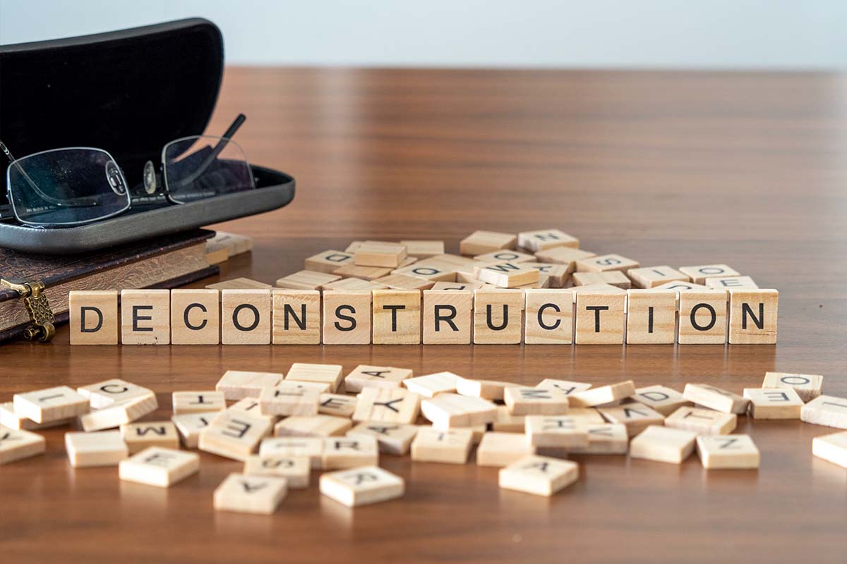 blocks on table spelling out deconstruction