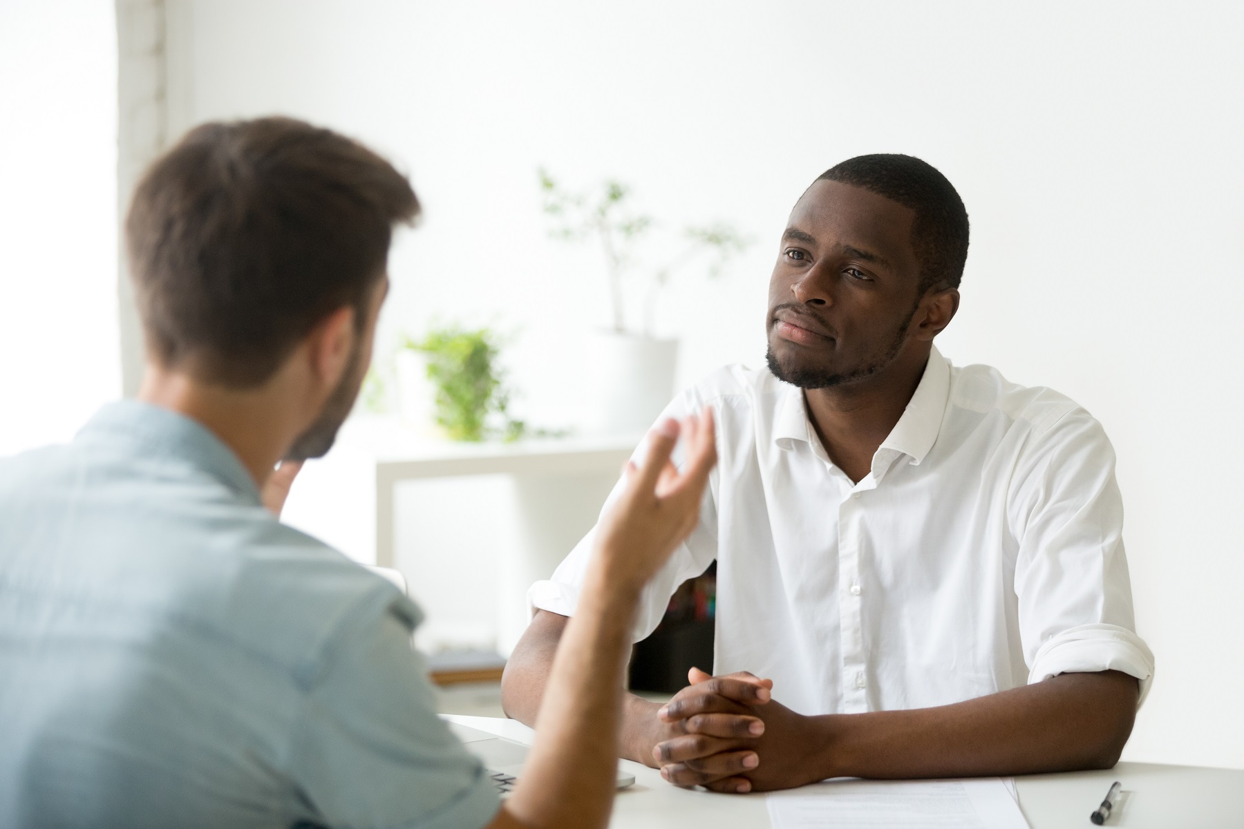 Man listening to other man share the gospel