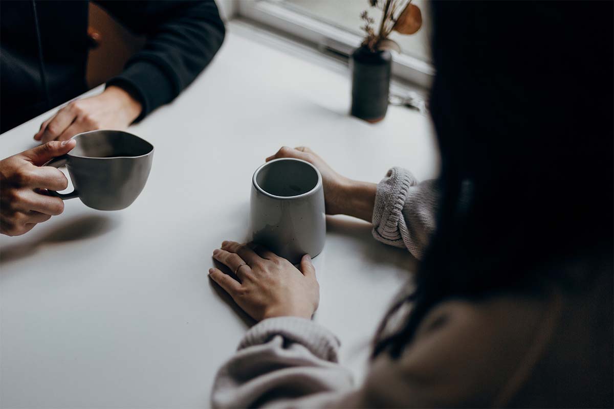 Two people sitting drinking Coffee