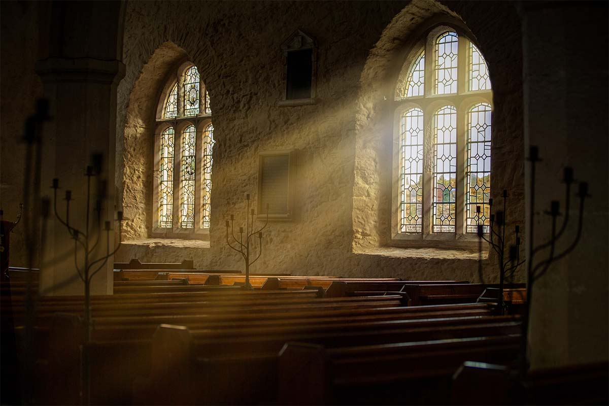 Image of windows in a church with light shining through